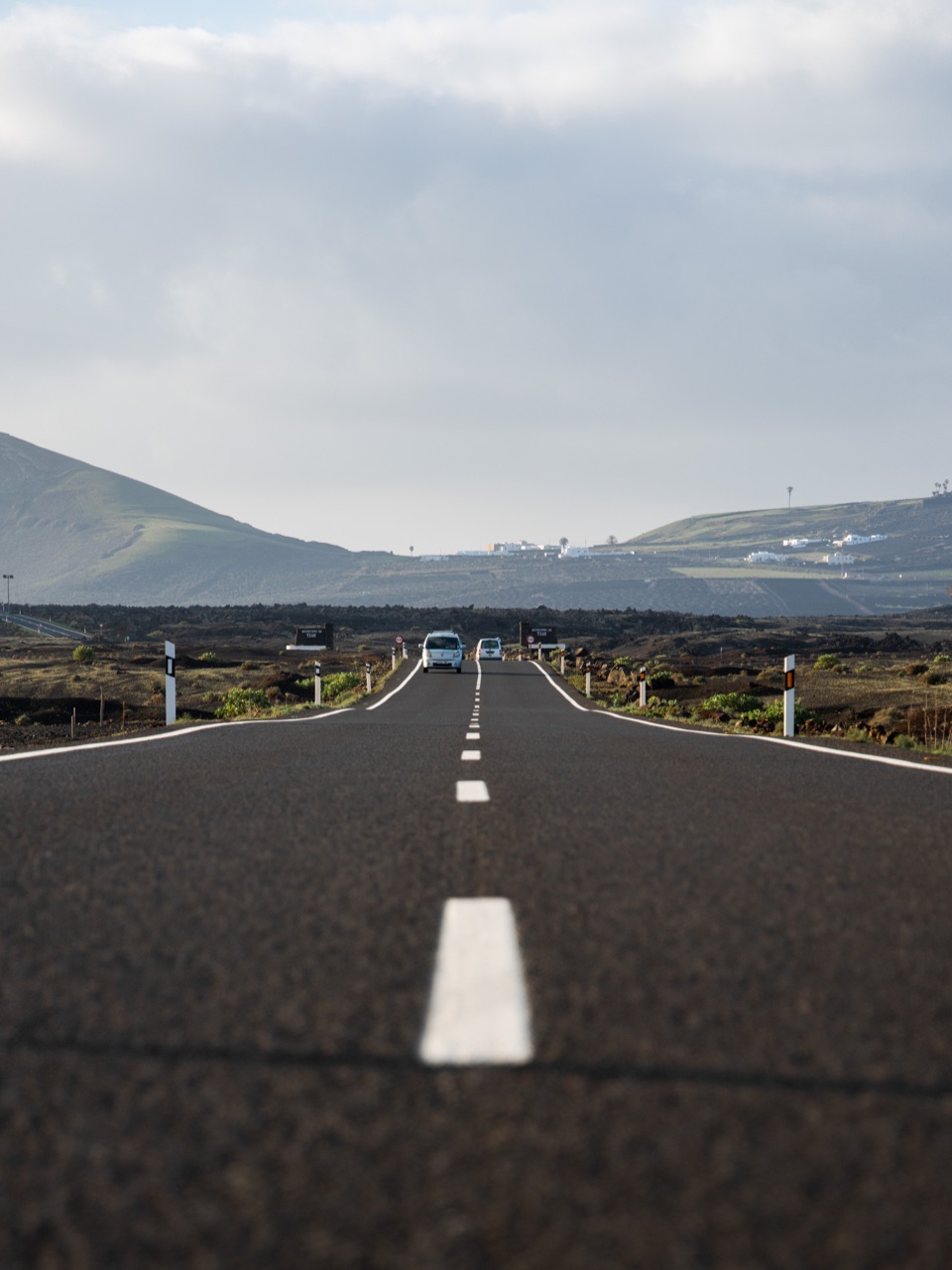 Gerade Straße durch eine weite vulkanische Landschaft